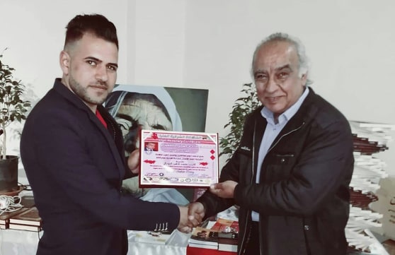 C:\Users\Duhok-Computer\Desktop\عصمت يستلم شهادة الكتاب العرب.jpg